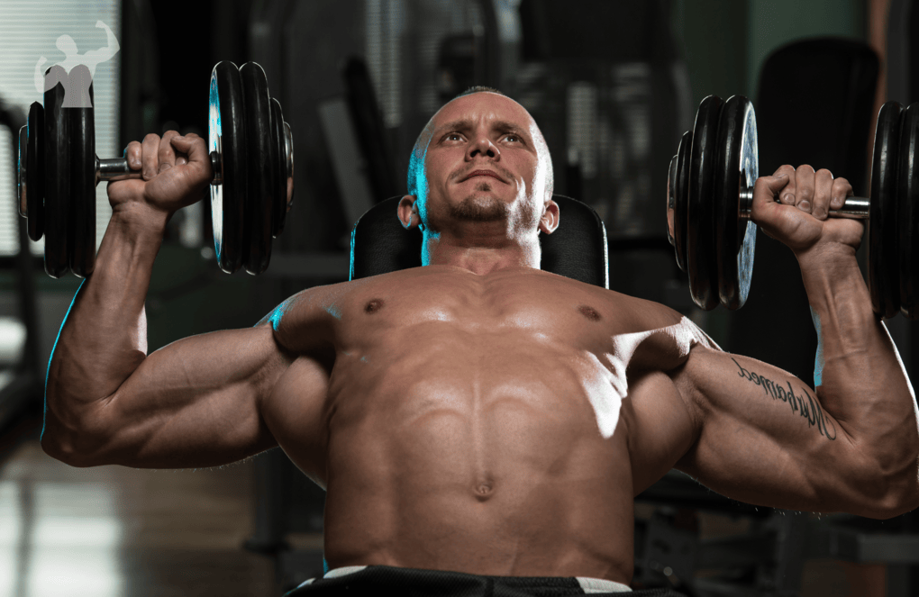 Image of a guy in a gym doing Incline Dumbbell Bench Press workout