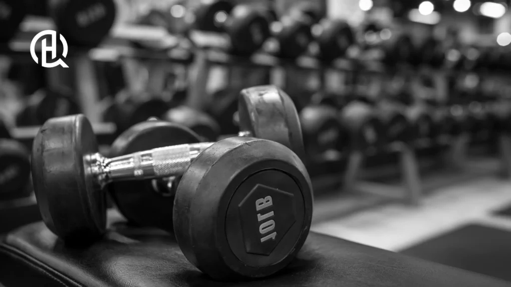 Dumbbells on Bench – Close-up of heavy dumbbells in a gym, symbolizing strength training.