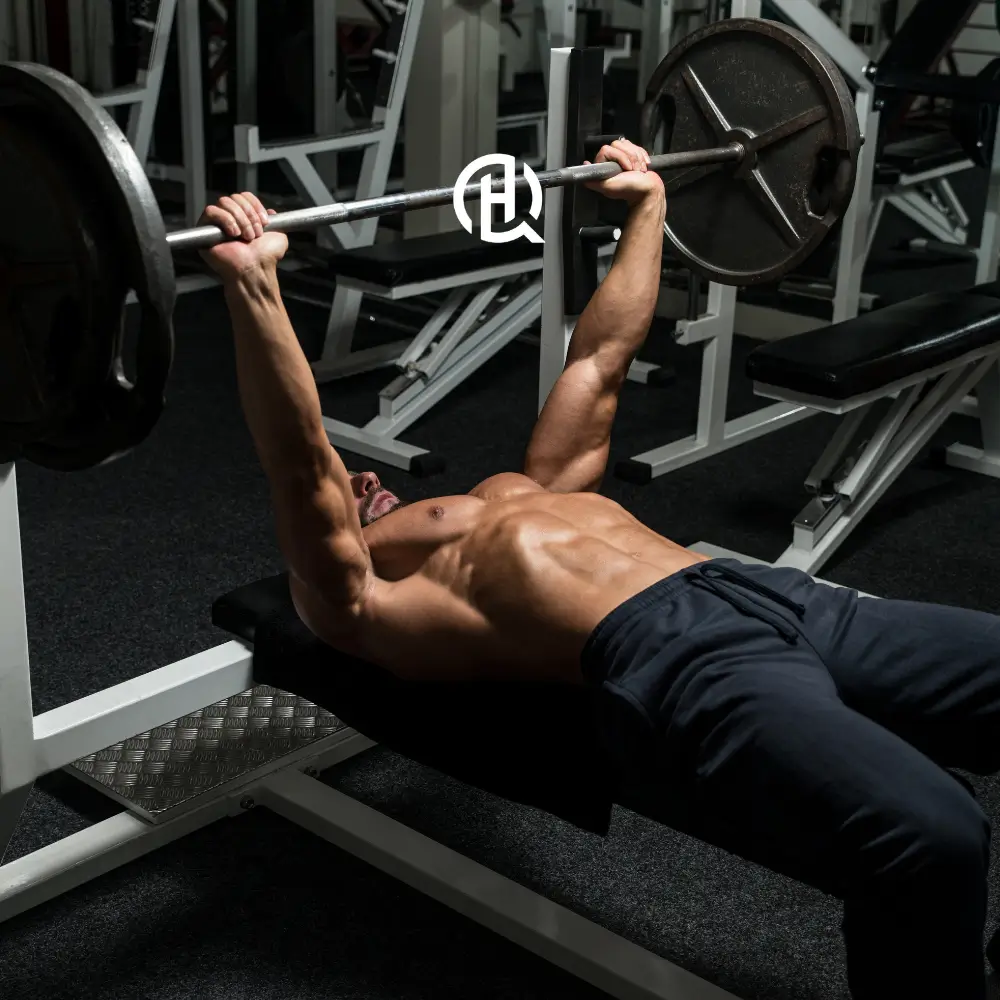 Man in gym doing barbell bench press