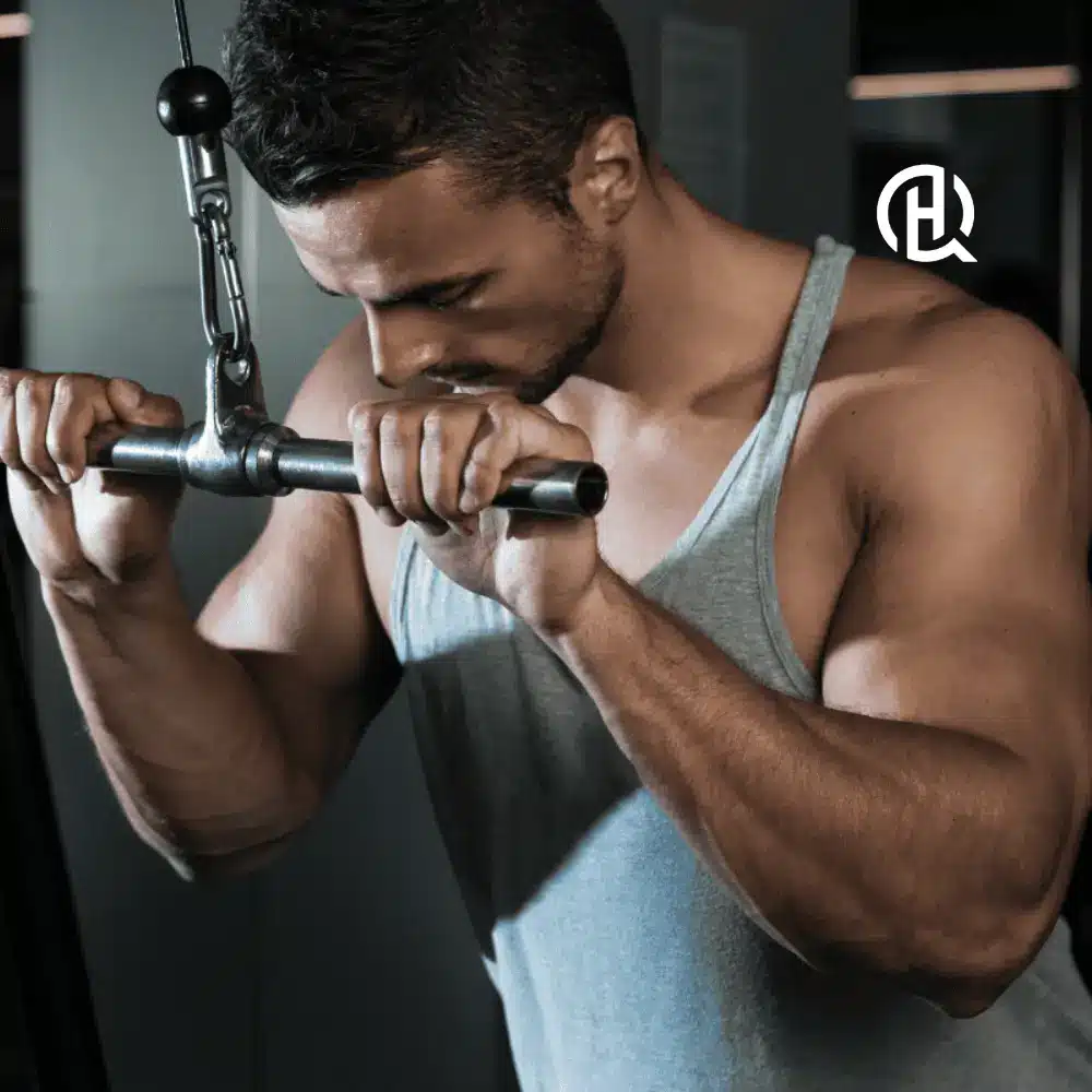 Man in gray top tank doing Triceps pressdown