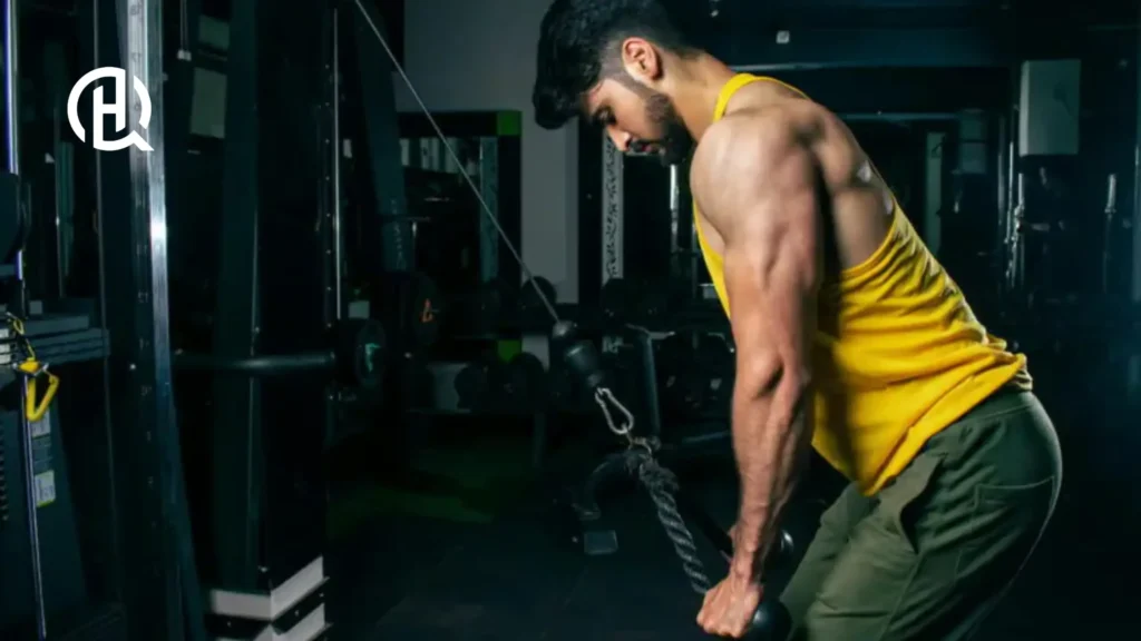 Man in yellow sando doing Cable rope pushdown