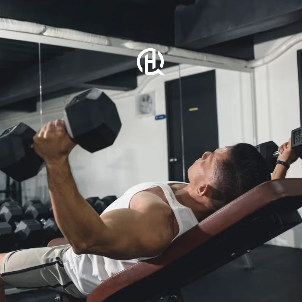 Man in white shirt doing Incline dumbbel fly in front of the mirror