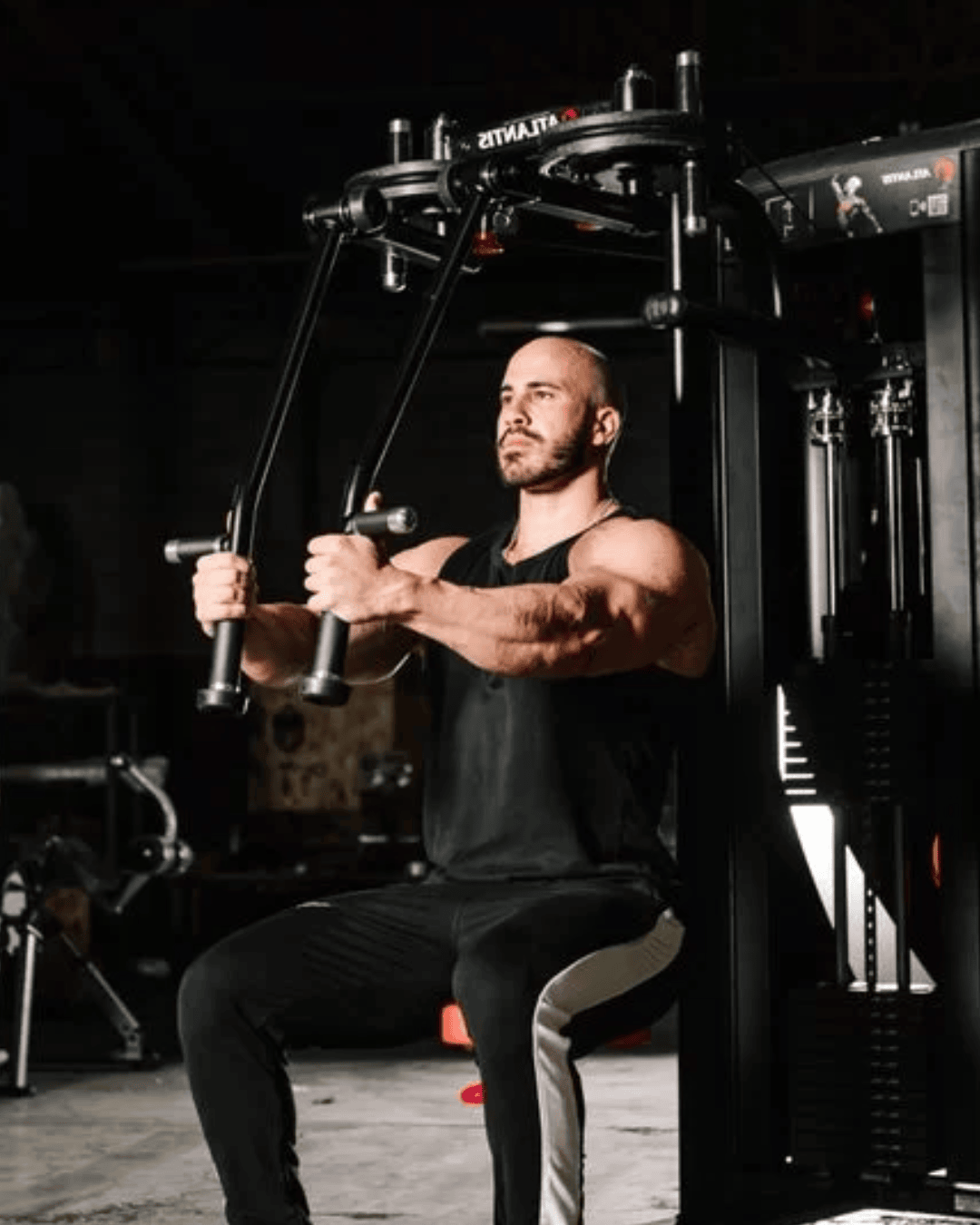 Guy doing the pec deck workout in a gym