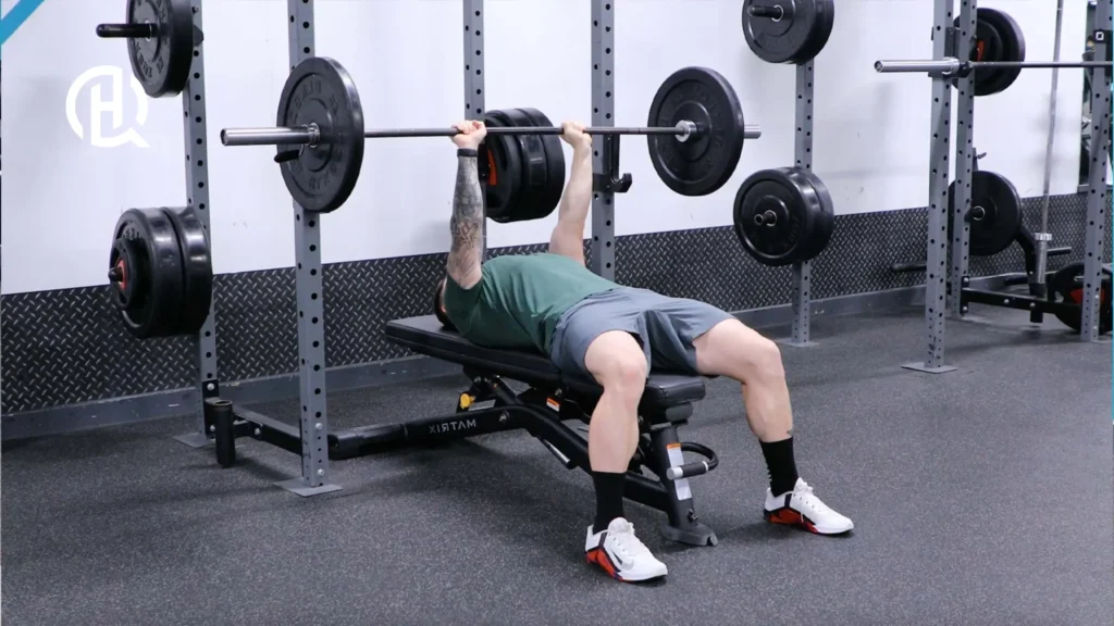Man in green clothes doing Close-Grip Bench Press