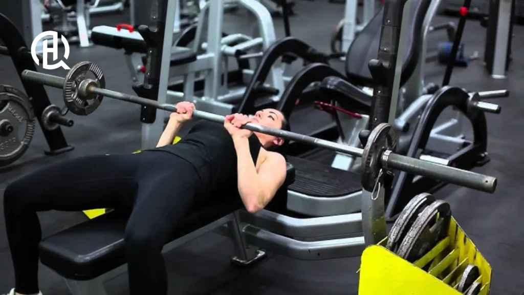 A woman demonstrating how to train bench.