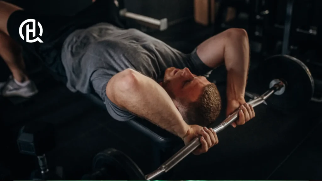 A person is lying on the bench whilst doing Tricep Exercises.