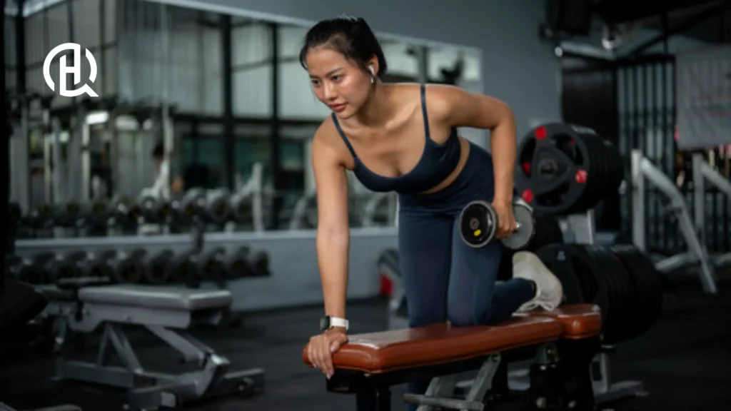 A girl doing triceps kickback.