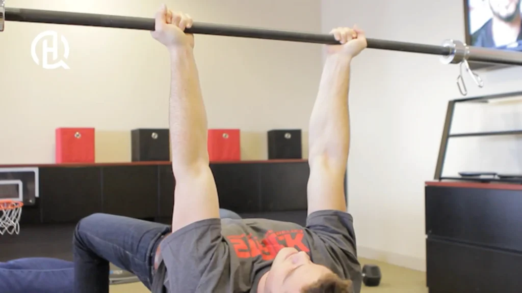 Man demonstrating reverse grip barbbell