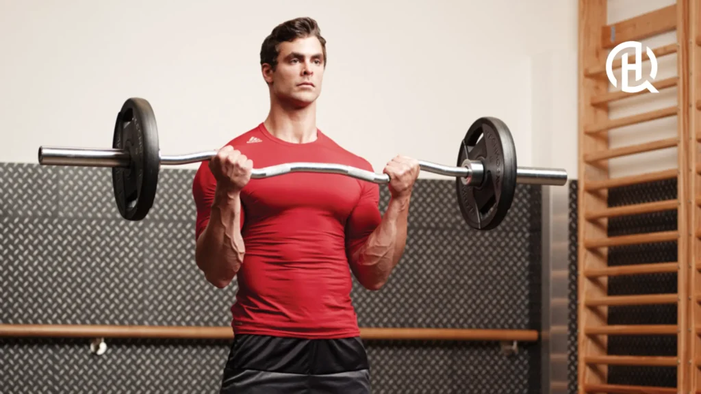 Man in red tshirt doing bicep exercises in a gym