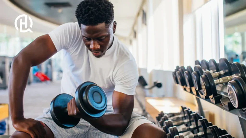 Man doing concentration curls, facing the camera.
