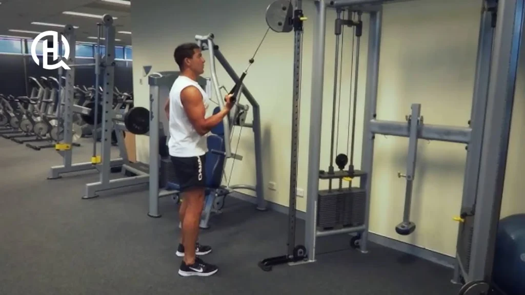 A person in a gym doing Single-Arm Cable Triceps Extension