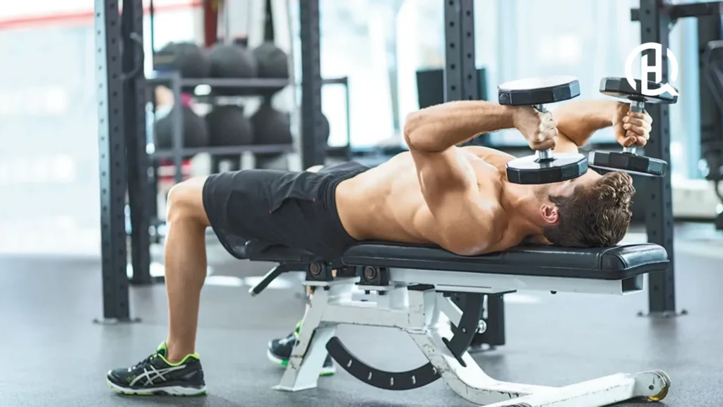 A man lying on a bench doing triceps extension
