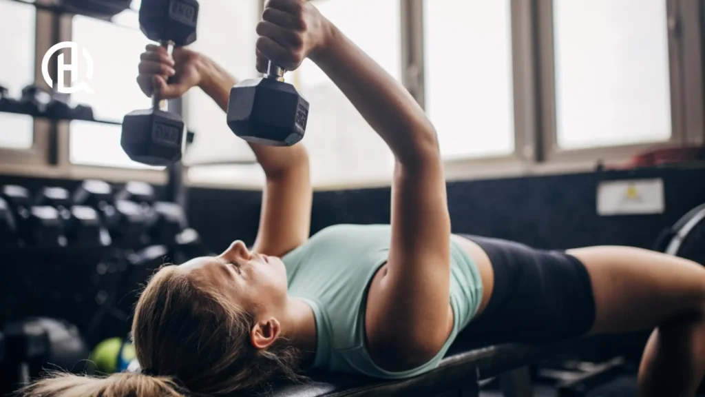 A girl doing Lying Dumbbell Triceps Extension