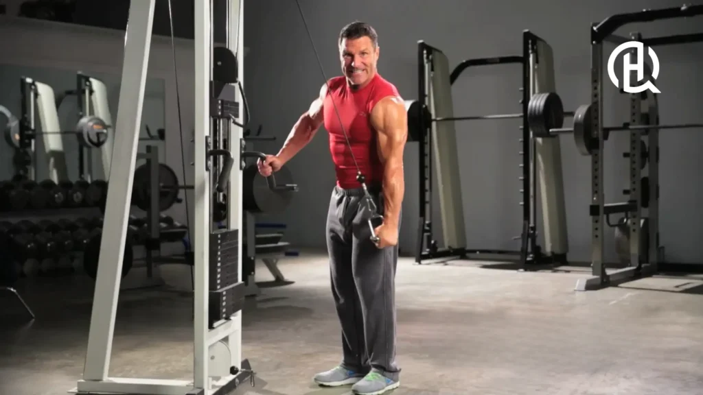 Man facing the camera as he is doing a Single-Arm Reverse Grip Cable Triceps Extension
