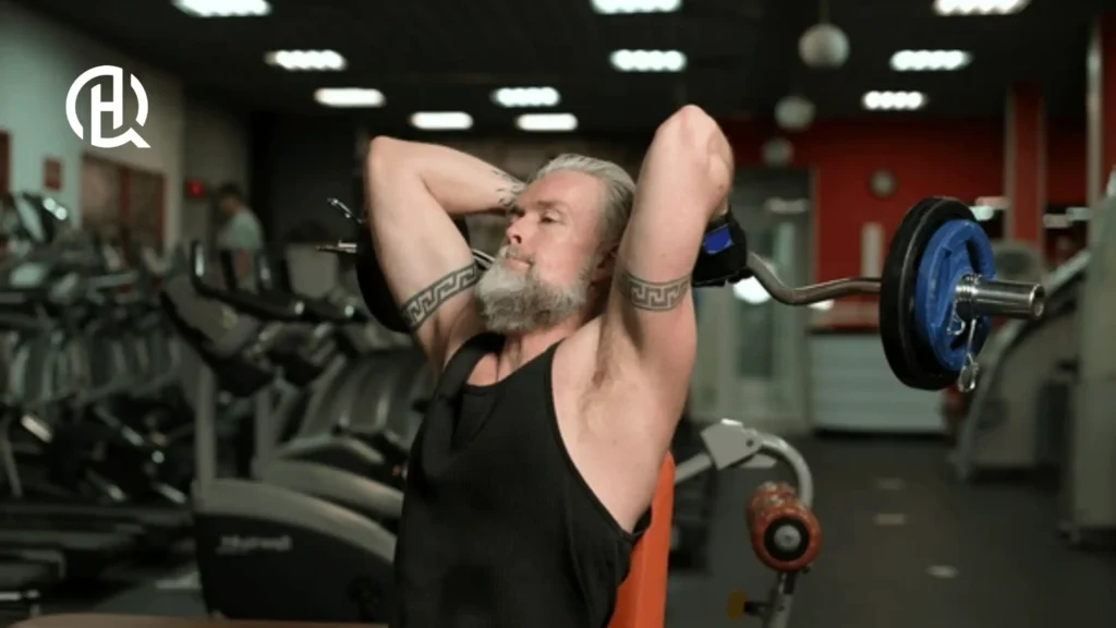 Man doing Seated Barbell French Press in a gym