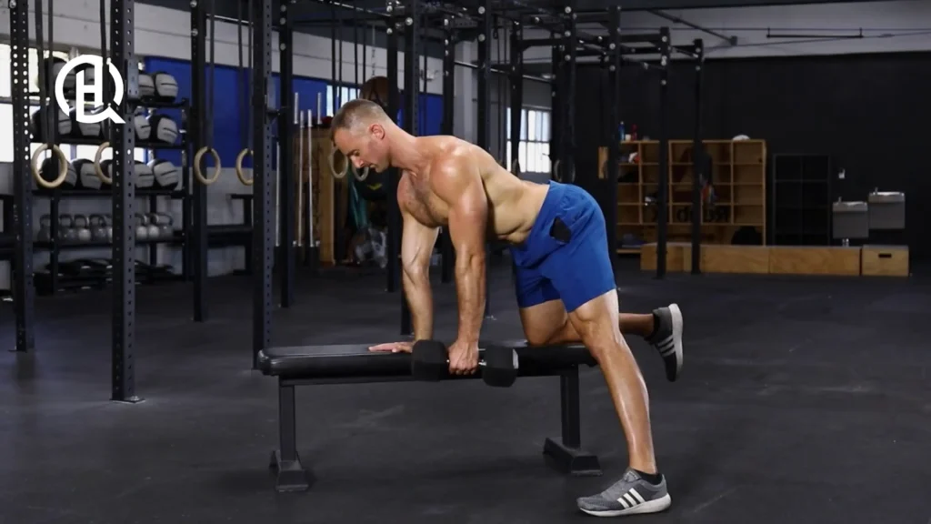 A man doing Dumbbell Bent-Over Row on a bench.