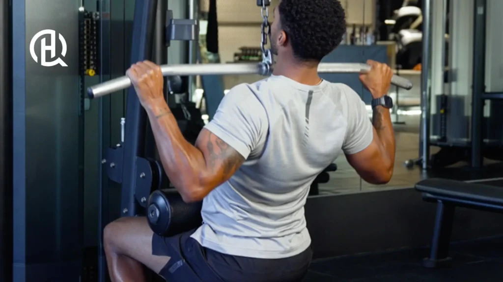 A young man doing Wide-Grip Pulldowns