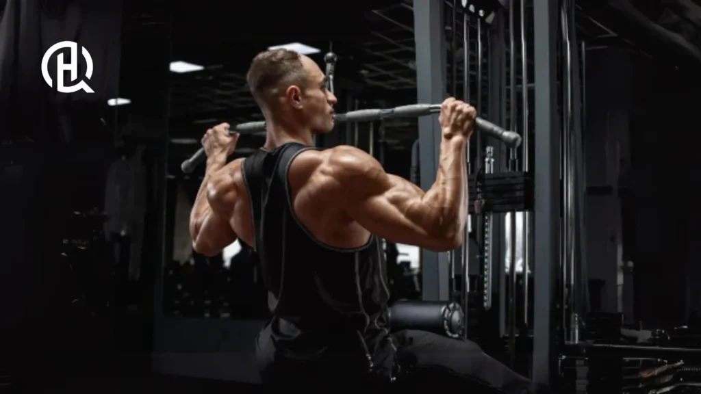 A man doing Wide-Grip Pulldown. He is wearing training clothes.