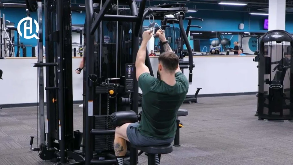 A man doing Close-Grip Pulldown, sitting down.