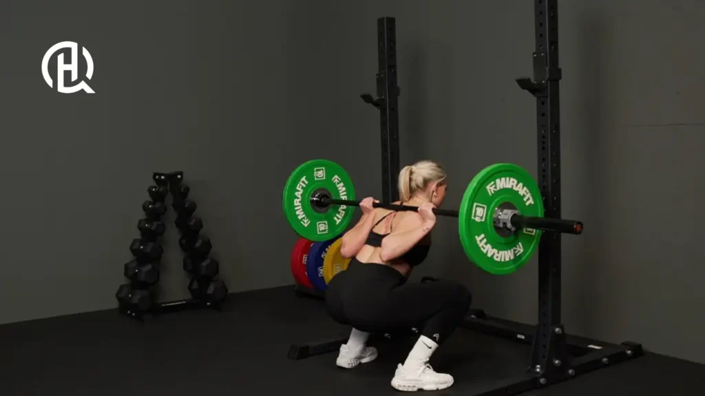 A woman doing a squat with a barbell